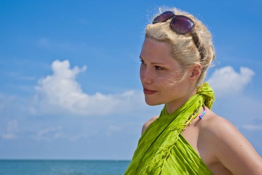 Young women looking on the sea, summer sunny day