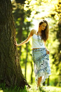  girl standing next to a tree portrait