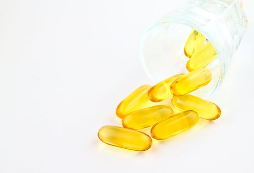 vitamins in glass on white background