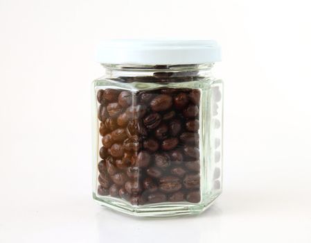 Coffee beans in a glass jar on white background