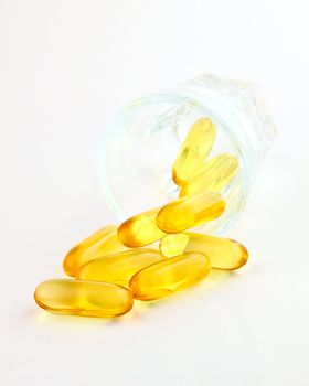 vitamins in glass on white background