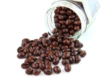 Coffee beans in a glass jar on white background