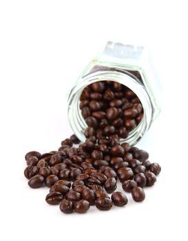 Coffee beans in a glass jar on white background