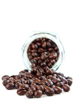 Coffee beans in a glass jar on white background