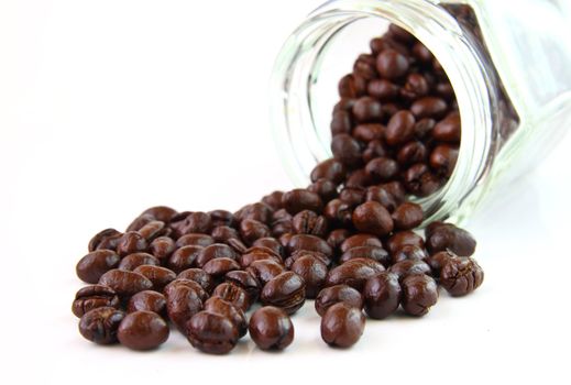 Coffee beans in a glass jar on white background