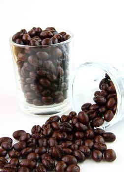 Coffee beans in glasses on white background