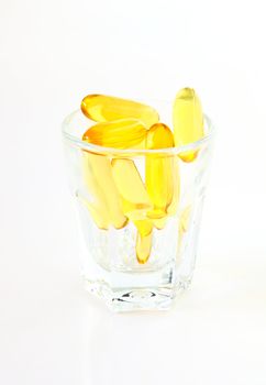 vitamins in glass on white background