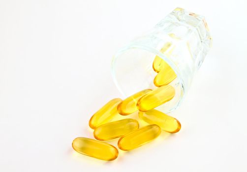 vitamins in glass on white background