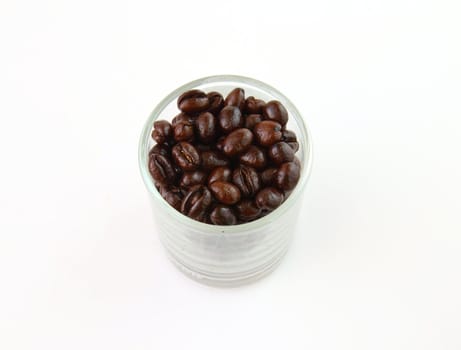 Coffee beans in a glass on white background