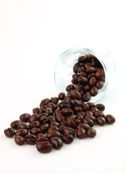 Coffee beans in a glass on white background