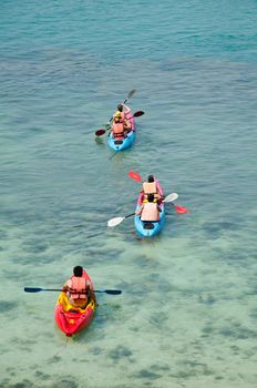 traveler kayaking in the thai ocean from backward view