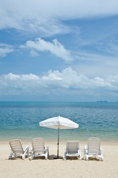 Beach chairs and umbrellas on beautiful tropical sand beach, Samui island Thailand.