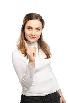 Beautiful young woman stands shaking finger.