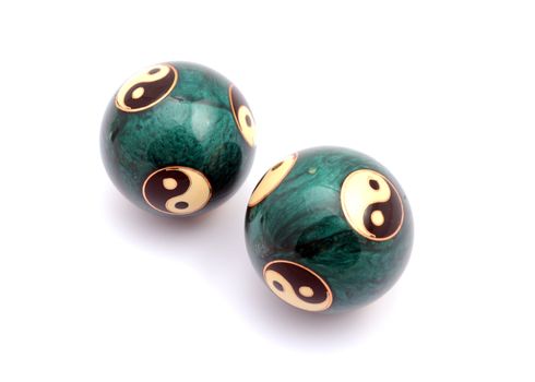 Green Chinese balls for relaxation on white background