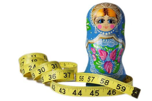 A thin Matrioska doll with a measuring tape around its waist