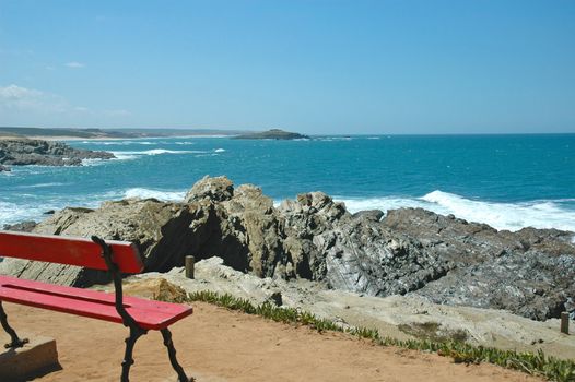 A bench with a view to the ocean and to a small island near the coast
