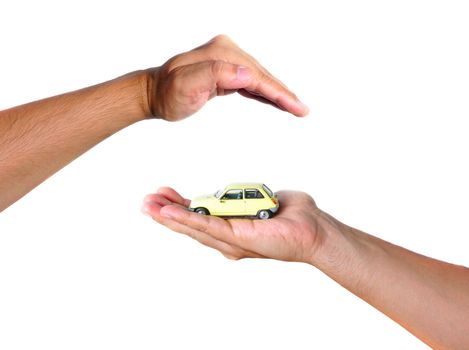 Two hands facing each other, protect a yellow car