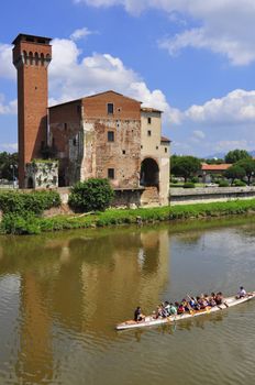 Guelph Tower of the old Citadel , Pisa , Italy, with a rower boat passing by