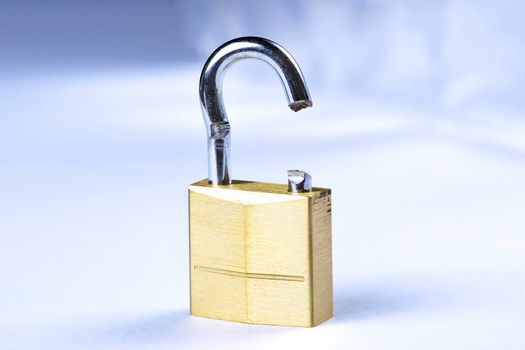 Image of a broken gold lock with a blue background