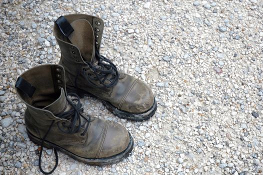 Old worn boots on a rocky floor