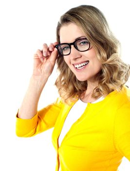 Smiling caucasian woman wearing and holding her glasses on white background
