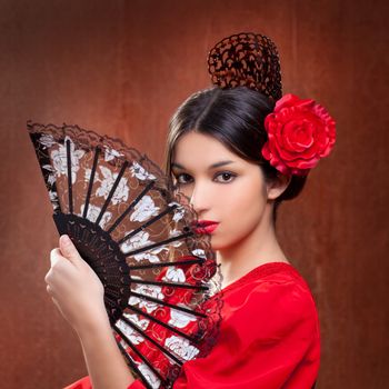 Flamenco dancer Spain woman gypsy with red rose and spanish hand fan