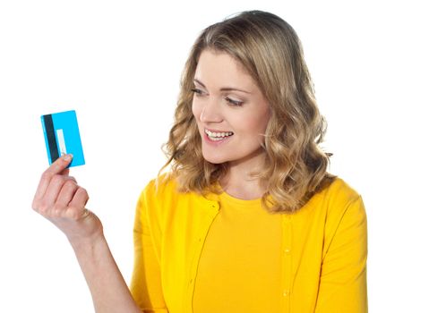 Attractive female holding her credit card isolated over white