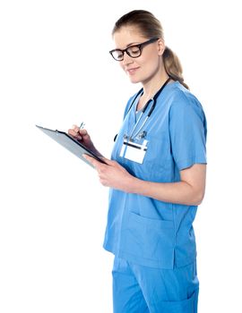 Female medical professional preparing report