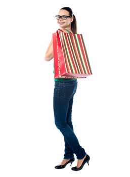 Lovely woman with shopping bags over white