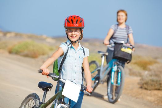 Beautiful girl and her grandmother on bikes. Lanzarote