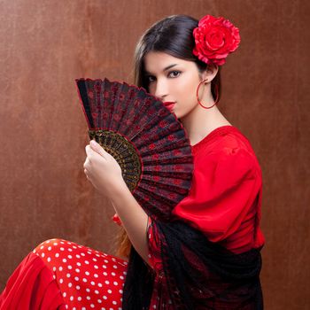 Flamenco dancer Spain woman gipsy with red rose and spanish hand fan