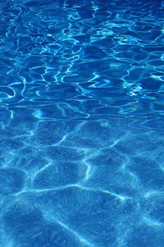A swimming pool cast in bright sunlight.