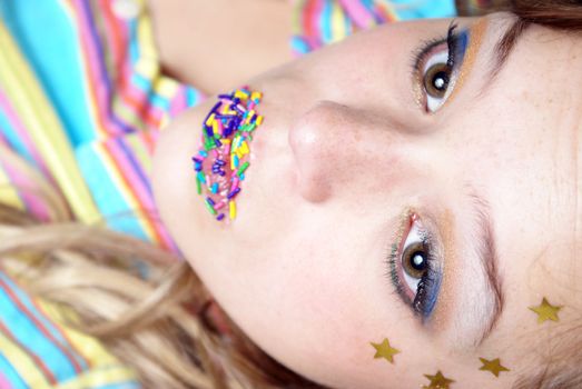 A woman looks out the frame in this playful glamor shot.  Shallow DOF with focus on the eyes.