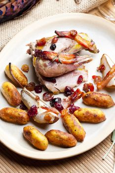 baked pheasant with bacon, pear, raisins on brandy