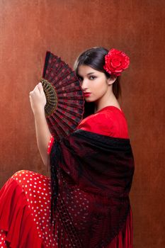 Gipsy flamenco dancer Spain girl with red rose and spanish hand fan