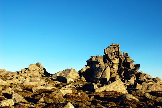 Huge rocks on the top of the mountains against blue sky