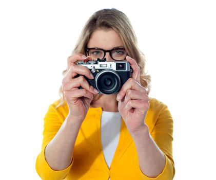 Young beautiful girl with the camera isolated on a white background
