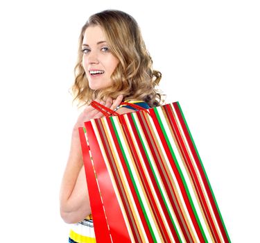 Close-up of happy shopping girl holding bags