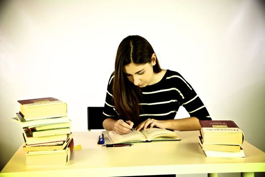 Girl studying book on a desk vintage effect