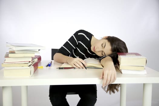 Lazy girl falls asleep while studying surrounded by books