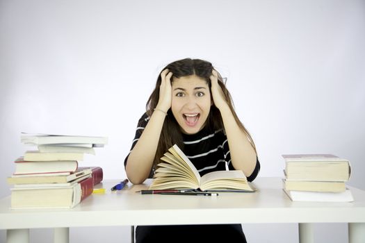 Girl studying book on a desk shouting