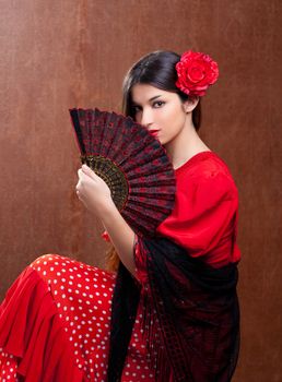Flamenco dancer Spain woman gipsy with red rose and spanish hand fan
