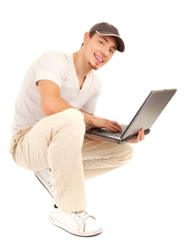 Handsome casual sitting man with laptop on white background