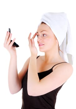 Young woman with white tower and nice manicure is admiring  nice eyebrows in the looking glass, on white background