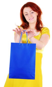 Young beautiul woman with blue paper bag in her hands on white background. Focus on woman's hands.