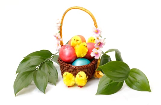 Basket with Easter Eggs on white background