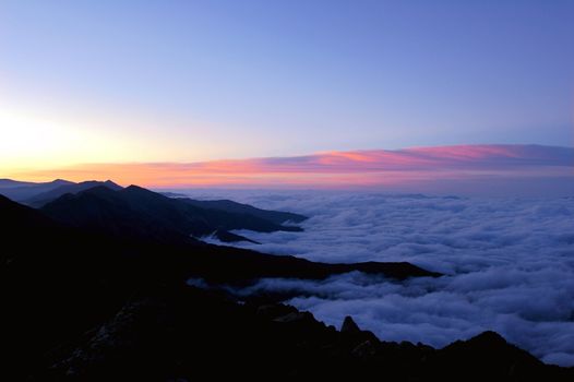 Cloudscape on the top of the mountains at sunrise