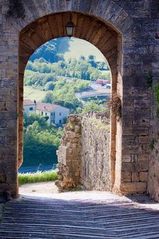 An old stone gates in an italian town in a sunny morning
