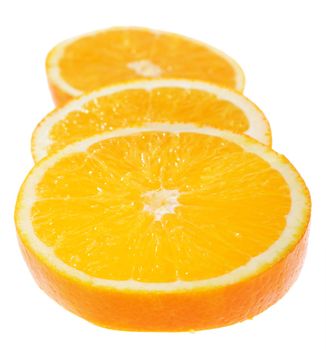 Juicy orange slices in very tasty view on white background. Focus on middСѓ of first slice. Shallow DoF.
