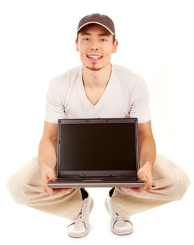 Handsome casual sitting man with open laptop on white background